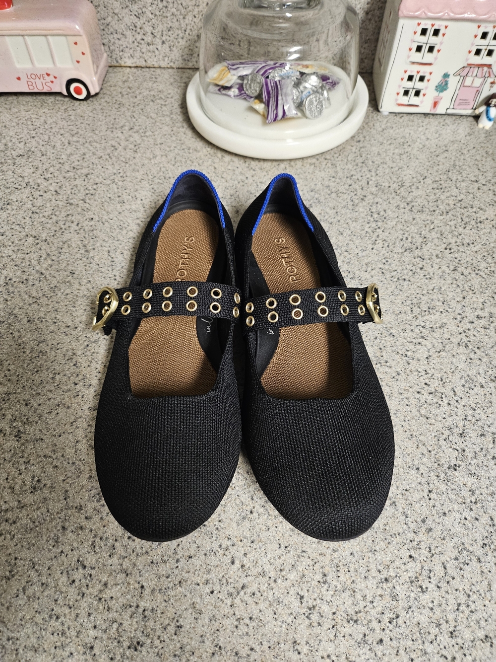 Rothy's Black Mary Jane Flats with Gold Grommet Strap and Blue Trim